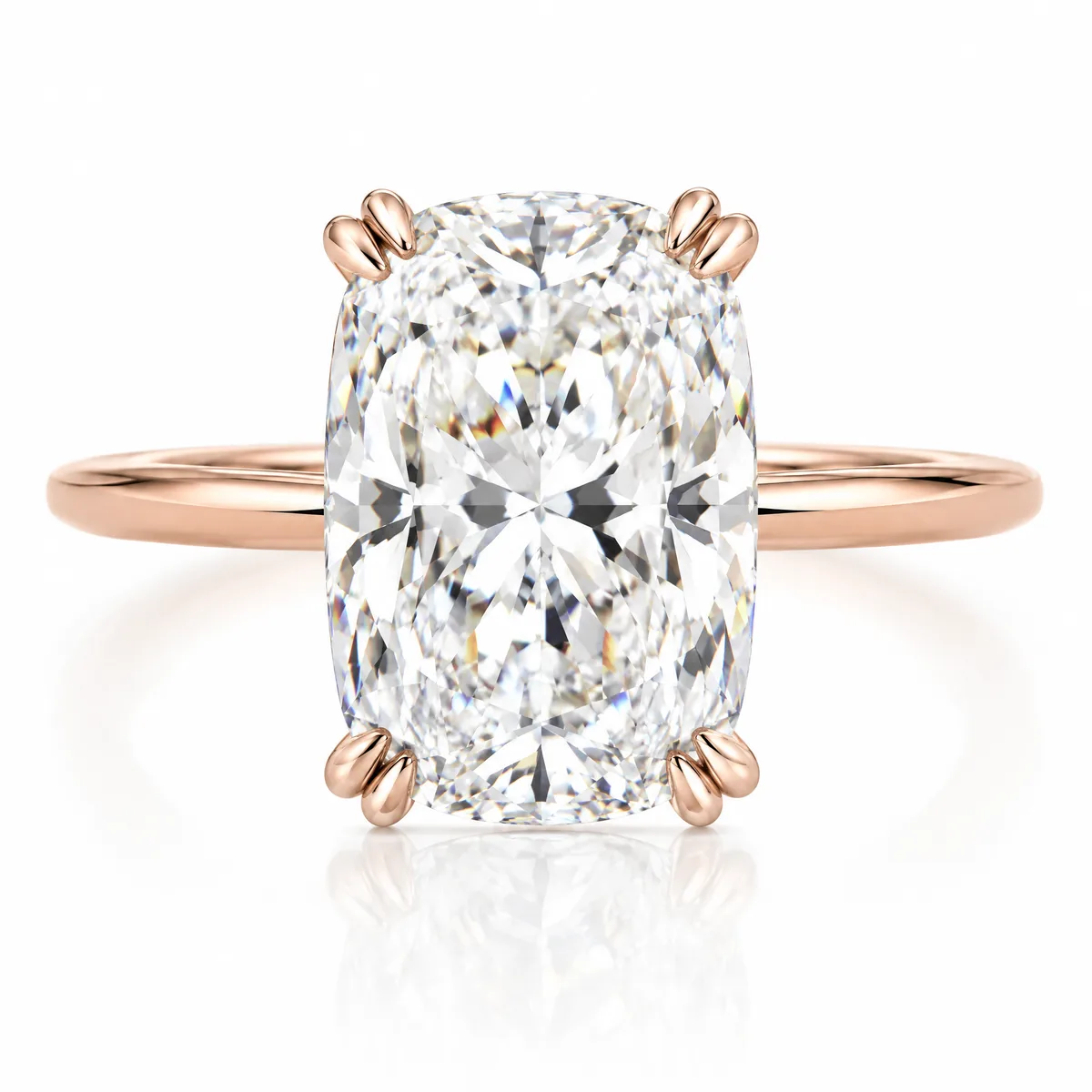 Elongated cushion: Elongated cushion-cut diamond with double claws on a knife-edge 18k rose gold band