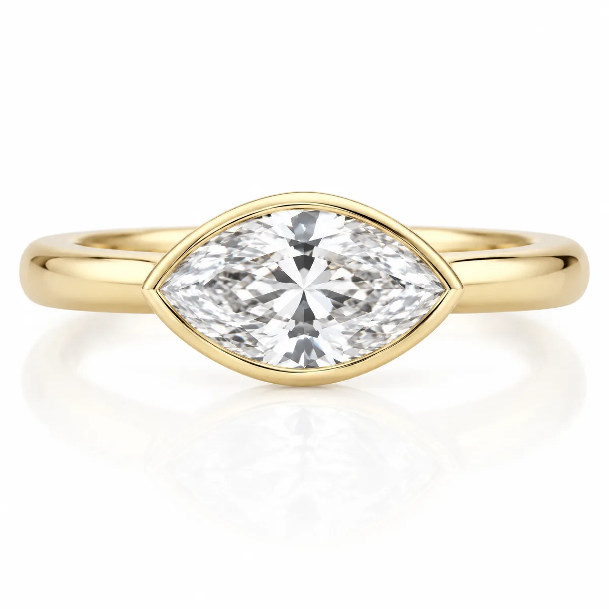 East-west marquise: Marquise-cut diamond set sideways in a bezel on a rounded 18k yellow gold band