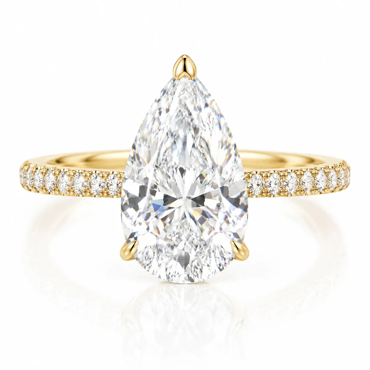 Pear pavé: Pear-shaped diamond solitaire on a pavé band in 18k yellow gold
