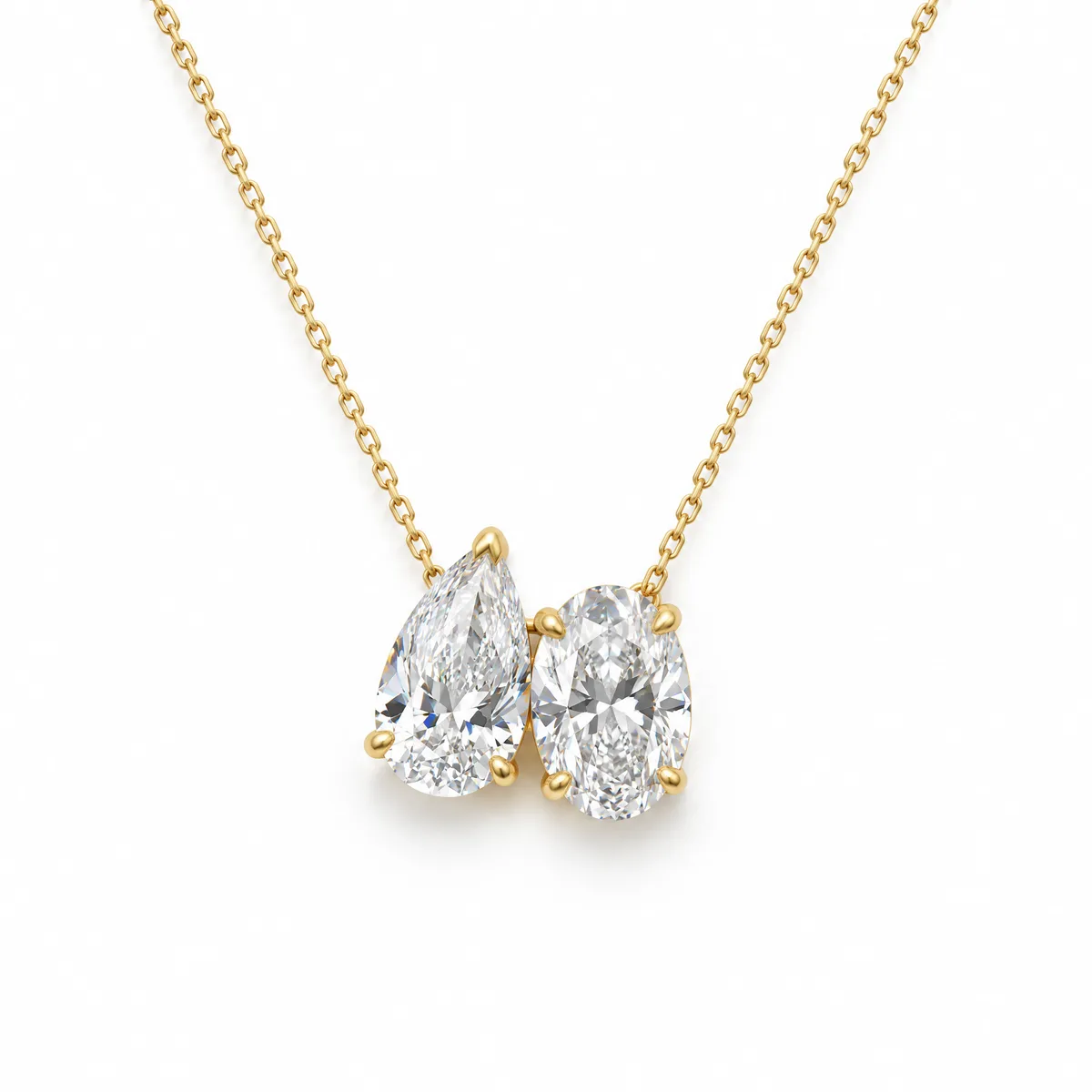 Toi et moi necklace: Pear and oval diamonds side by side on a fine 18k yellow gold chain