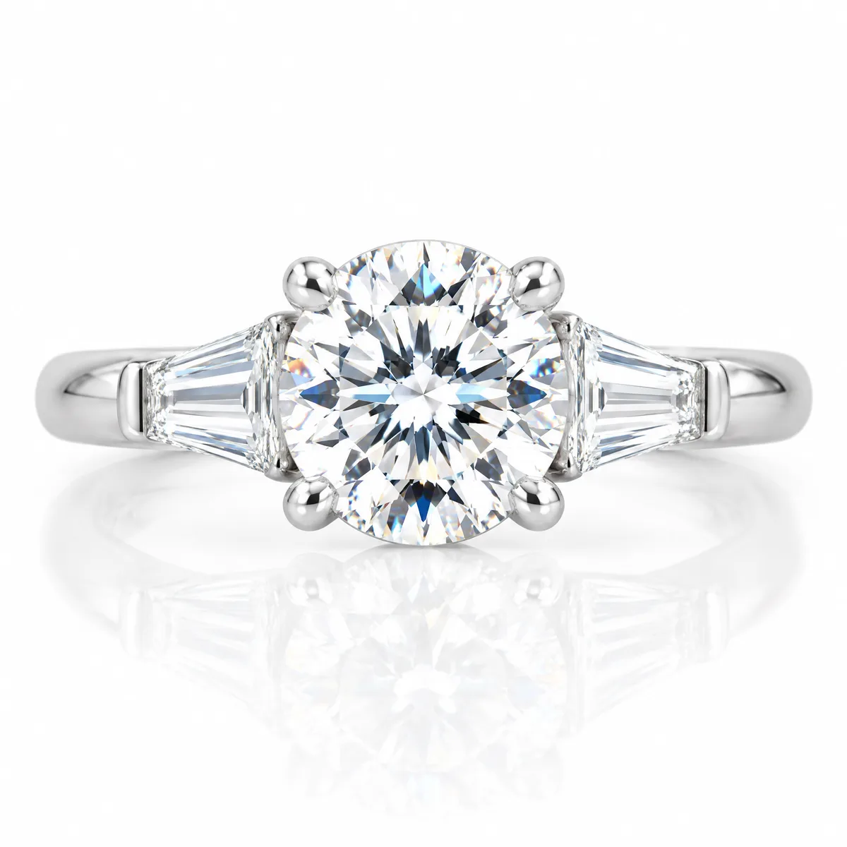Three-stone baguette: Round brilliant diamond flanked by tapered baguettes, set in 18k white gold